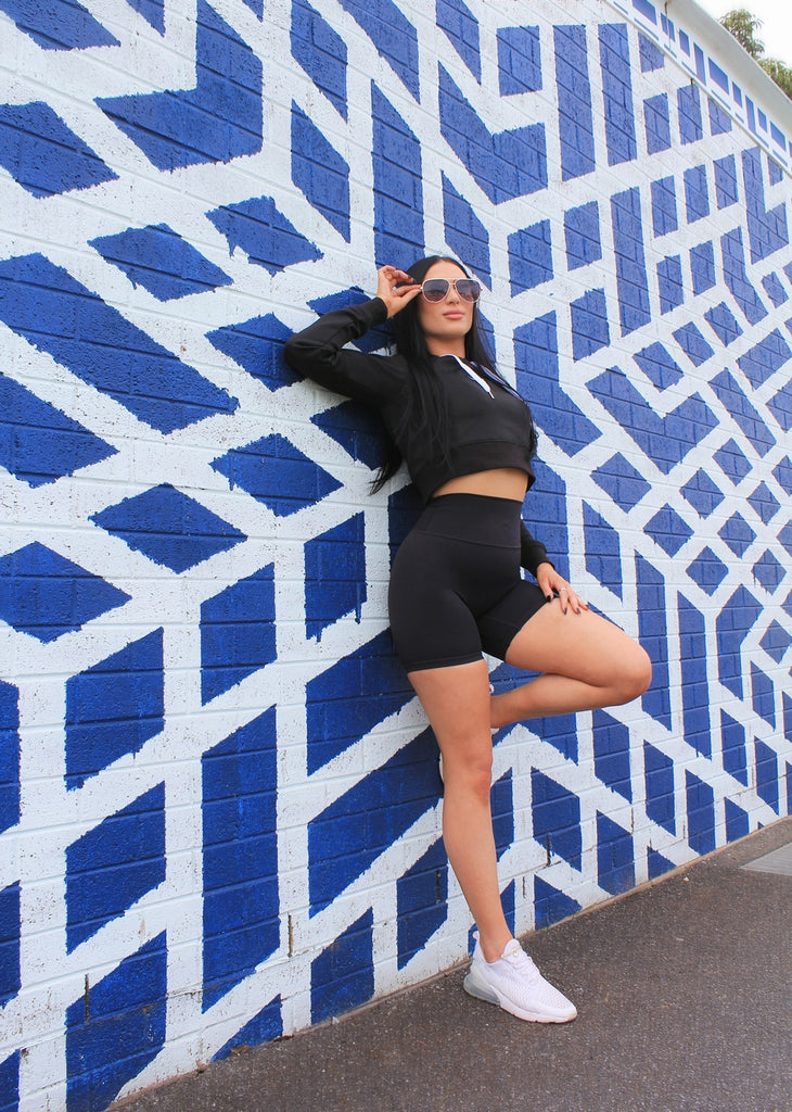 Model pose on colourful wall Pintrest activewear Shorts Black hair